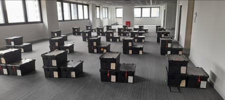 Stacks of nondescript black boxes arranged in neat lines