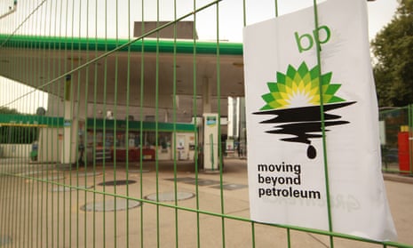 A Greenpeace poster displaying a leaking oil logo on closed a BP petrol station in Camden, London