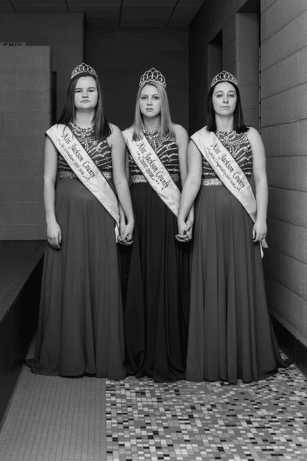 Three women in dresses and Miss Jackson County sashes