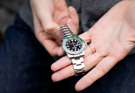 Hartog holds a Rolex watch given to him by Ollie Millroy and his wife, Fern.