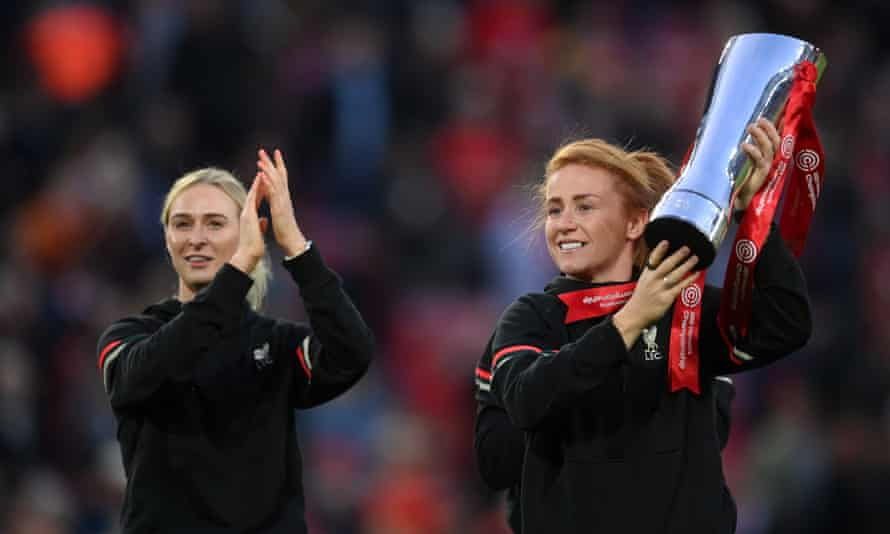 Liverpool's Rachel Furness carries the FA Women's Championship trophy in mid-season.