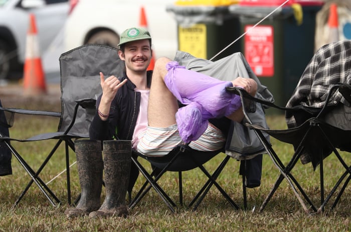People who arrived on Thursday have had their campsites washed out. One attendee is taking double-precautions against the mud, with plastic bags on his legs as well as gumboots.