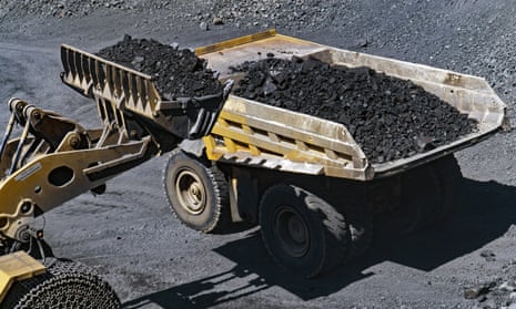 A front loader loads a dumper truck with freshly blasted rock containing iron ore at the Yeristovo and Poltava iron ore mine, operated by Ferrexpo