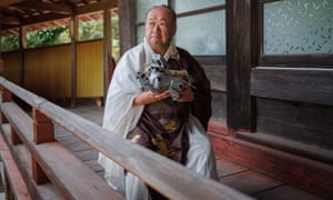 Kofukuji temple chief priest Bungen Oi holds a pet Aibo robot dog after a robots’ funeral