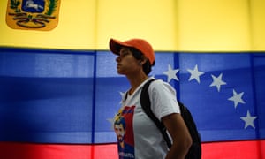 A supporter of Venezuelan opposition leader Juan Guaido listens as he speaks in Caracas on Monday. 4830.jpg?width=300&quality=85&auto=forma