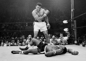 Muhammad Ali, then known as Cassius Clay, stands over challenger Sonny Liston, in 1965.