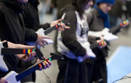 A line of people playing plastic instruments.