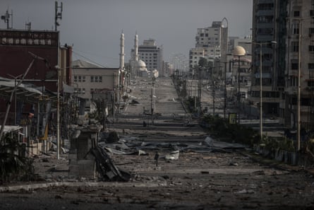 A long street lined with damaged buildings and debris