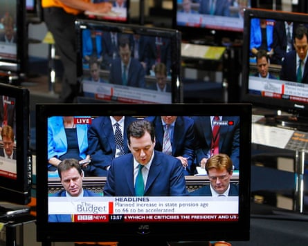 George Osborne making his first budget speech in 2010, seen on television screens in an electrical store in Edinburgh.