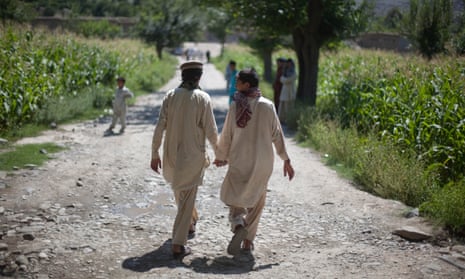 Afghan boys holds hands while leaving their school in the village of Asmar, Kunar province, Afghanistan. 