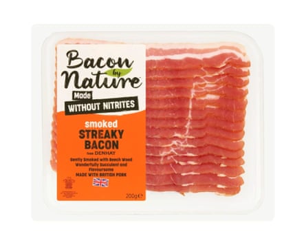 A packet of Denhay Bacon By Nature Smoked Streaky Bacon Nitrite Free. There is a clear back and the rashers are clearly visible with a branded label wrapped around the left side of the packet.