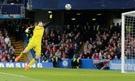 Thibaut Courtois tries in vain to keep out Charlie Adam’s effort from inside his own half.
