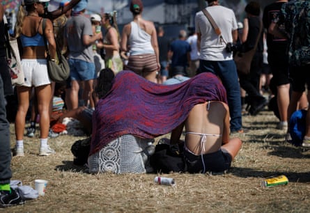 Festival-goers struggle in the heat by the Other stage.