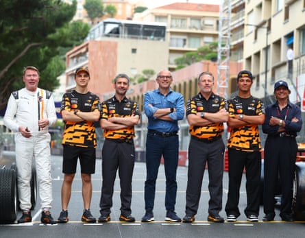 Mika Häkkinen, Oscar Piastri, Andrea Stella, Stefano Domenicali, Zak Brown, Lando Norris and Emerson Fittipaldi pose for a photo during previews ahead of the F1 Monaco Grand Prix