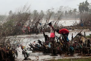 Residents inspect an area filled with plastic rubbish after the passing of Hurricane Iota, in Puerto Cabezas, Nicaragua.