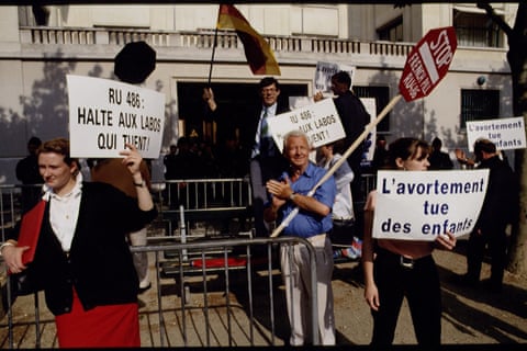 Demonstrators in Paris, France, in 1993 hold signs.