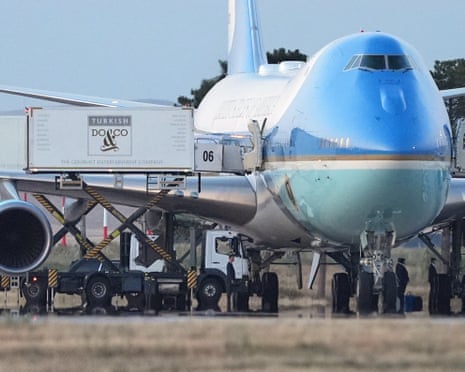 Catering trucks are parked at Air Force One on the tarmac