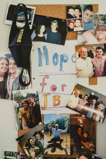 A close-up view of family photos pinned to a corkboard