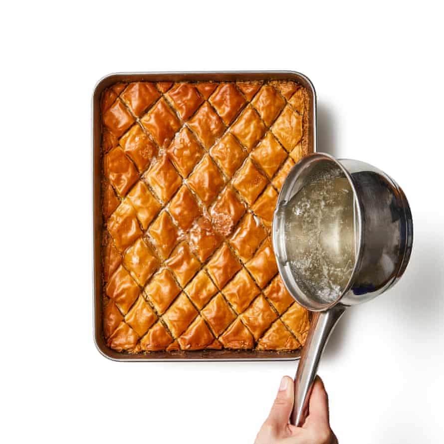 Felicity Cloake’s Baklava 09a Remove the from the oven and turn up the heat to 200C (180C fan)/390F/gas 6. Pour the syrup over the top of the baklava, especially along the pre-cut lines, and return to the oven for five minutes. Leave to cool completely, then run a knife along the lines to loosen them before attempting to lever the pieces out of the tin.
