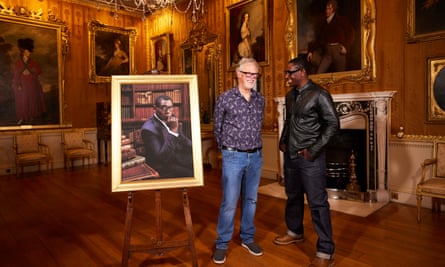 David Lascelles and David Harewood stand next to a portrait at Harewood House in Leeds