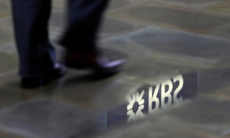 A man passes a puddle with the RBS logo reflected into it