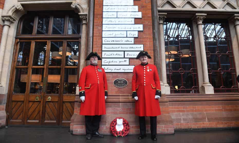 Chelsea pensioners next to the war memorial inside St Pancras International station.