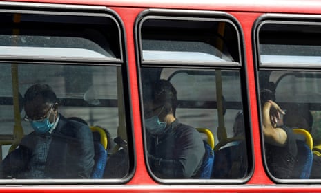 Passengers wear protective face coverings on a London bus.