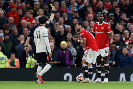Pogba is shown a yellow card by referee Anthony Taylor.