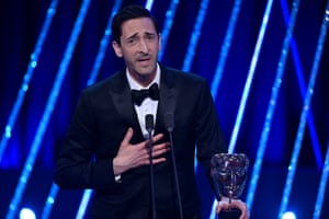 Adrien Brody accepts the leading actor award for The Brutalist