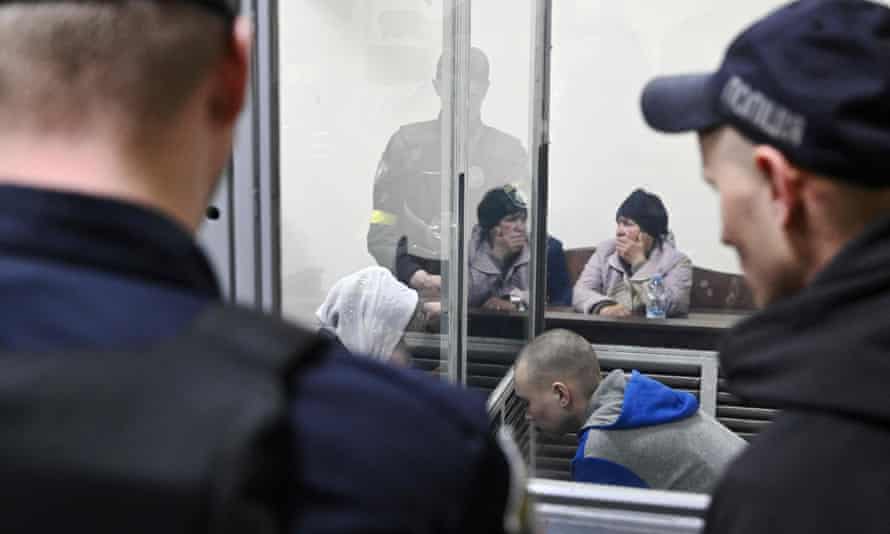 Russian soldier Vadim Shishimarin (bottom C) looks on from the defendant’s box, as the victim’s widow Kateryna Shelipova (top) reacts.
