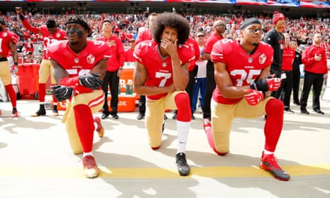 Colin Kaepernick, centre, and San Francisco 49ers team-mates Eli Harold, left, and Eric Reid kneel in protest against police brutality and oppression during the national anthem before last year’s game against Dallas Cowboys.