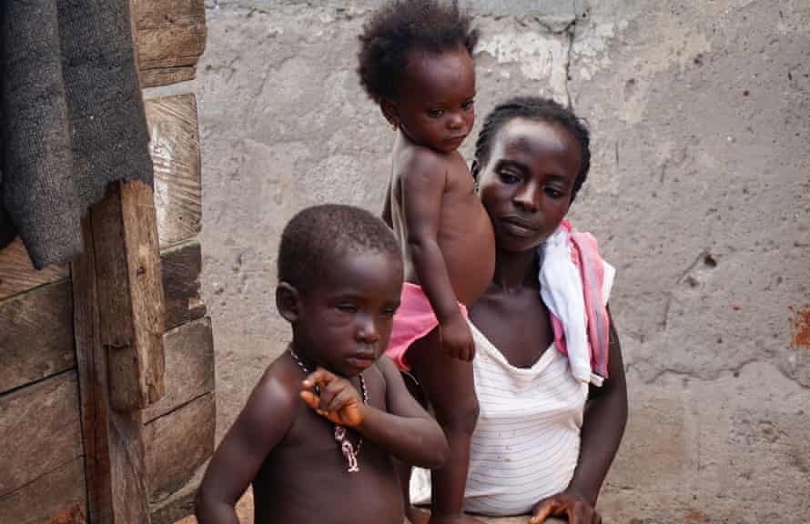 Ama, in her 20s, with her two children at home in Nyanyano