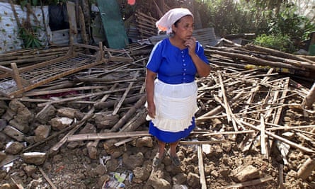 A women stands amid the ruins of her destroyed house in Comasagua, El Salvador, in January 2001, two days after an earthquake rocked Central America.