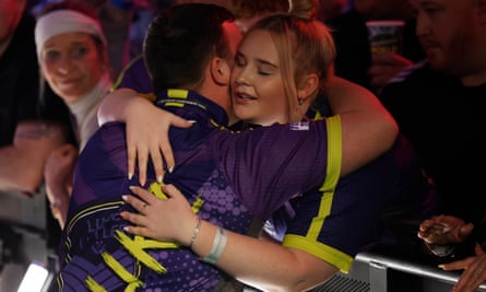Luke Littler hugs his girlfriend Eloise Milburn during his walk on before the world darts championship final.