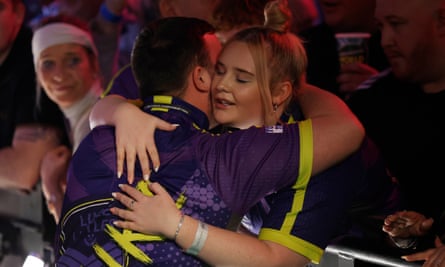 Luke Littler hugs his girlfriend, Eloise Milburn, before the PDC World Darts Championship final at Alexandra Palace
