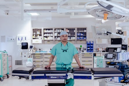 Shehan Hettiaratchy standing in a room filled with medical equipment and supplies