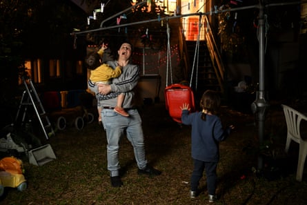 Trans man Coonan and his children are photographed at their home in Brisbane