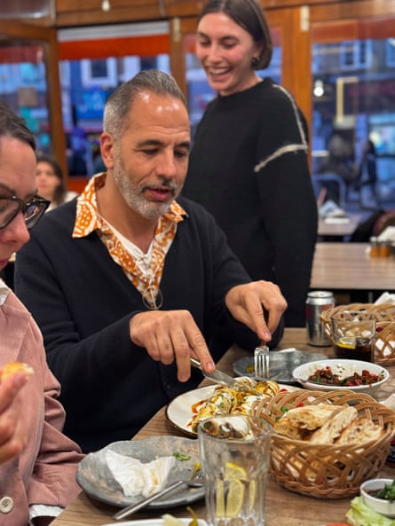 Smiling man in a restaurant eating Turkish food