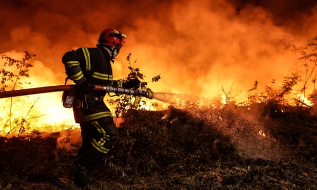 A firefighter tackles a wild fire in Gironde, France, 17 July 2022.