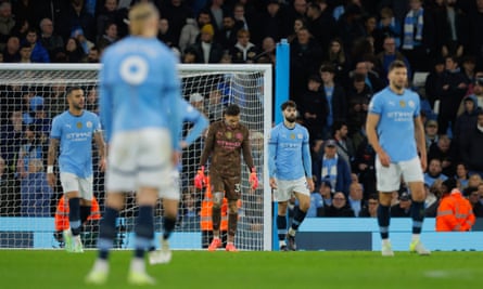 Manchester City players are stunned as the match runs away from them late on at the Etihad
