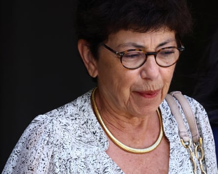 Monique Barbut with short hair and glasses wearing a patterned white shirt.