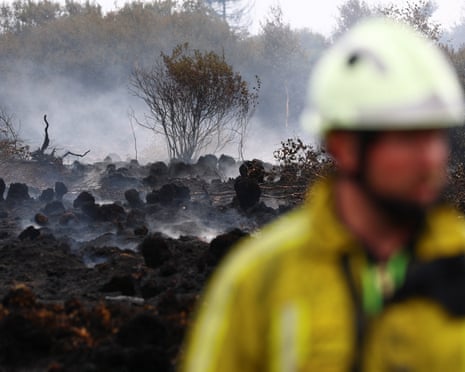 A Belgian firefighter in a field affected by a wildfire in Waimes, in the High Fens (Hautes Fagnes) region, Belgium.
