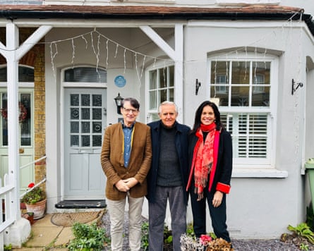Geoffrey Marsh, George Underwood and Nicola Stacey stand outside the front of a house panted grey
