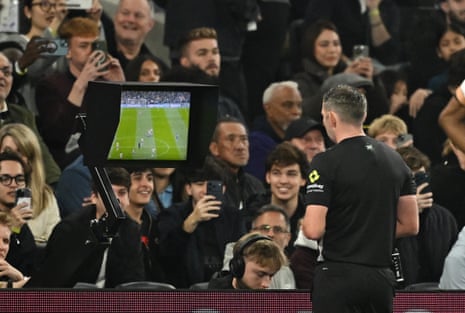 Referee Michael Oliver looks at the VAR monitor