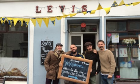 Musicians stands with a blackboard advertising their gig at Levis Corner House Ballydehob, in West Cork, Ireland.