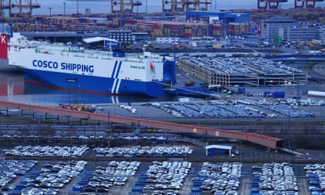 Lines of cars and ship in port
