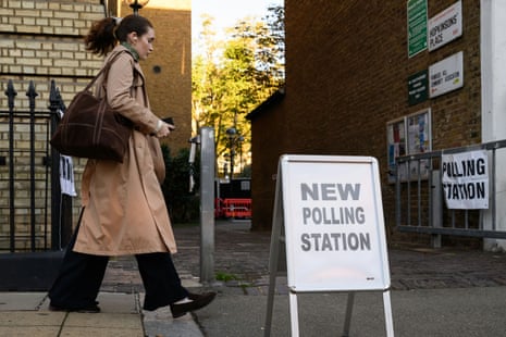 A woman walks past a polling station