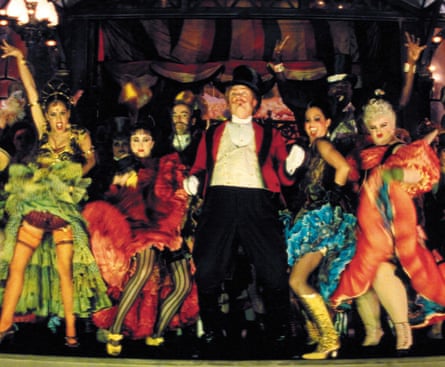 A group of actors in colourful costimes on stage