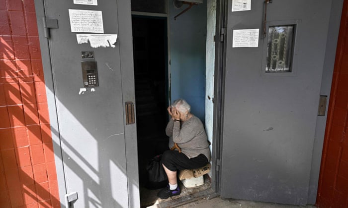Galyna Chorna, 75, cries after a rocket strike damaged the nine-storey building where she lives in Saltivka, on the outskirts of the Ukrainian city of Kharkiv