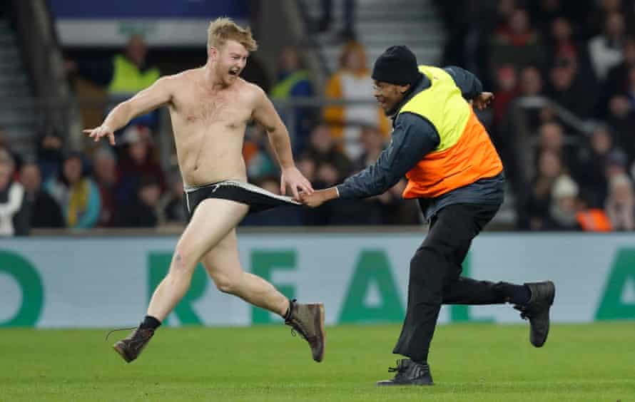 FIFAPRO Tom Jenkins’s best sports photos of 2018 30 A streaker is grabbed by a steward as he runs on the pitch during the England v Australia autumn international rugby union match at Twickenham Stadium on November 24th 2018